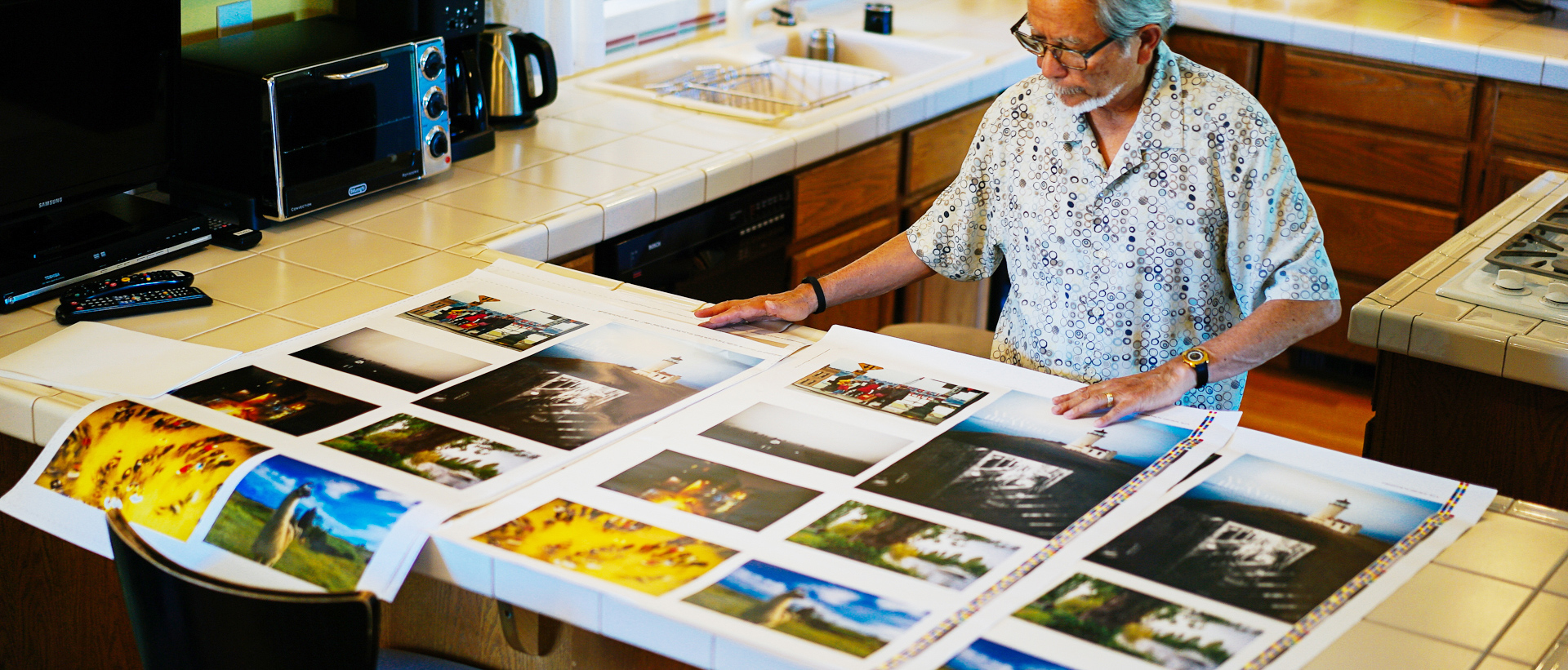 Scott Tsumura laying out proof prints across the kitchen counter